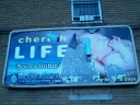 A pro-life billboard peeling away